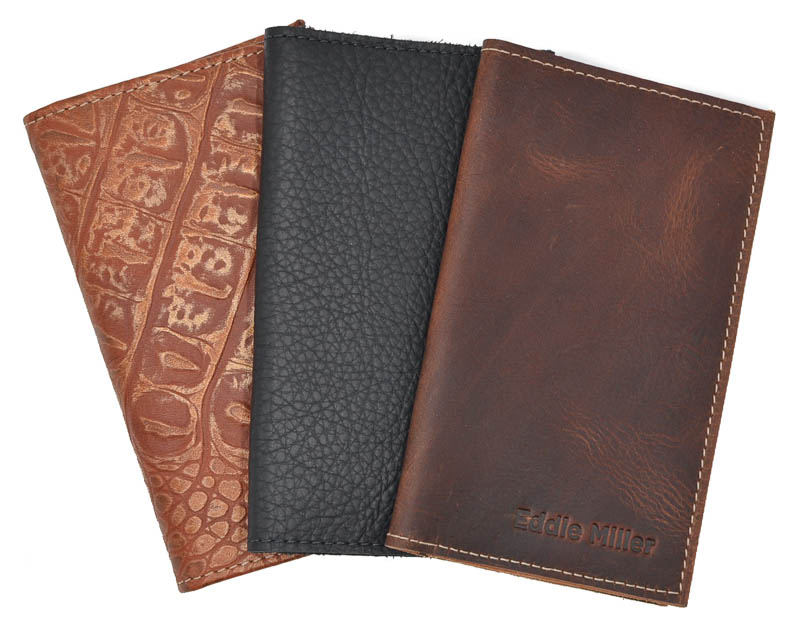 black, tan, red and greed leather tally books